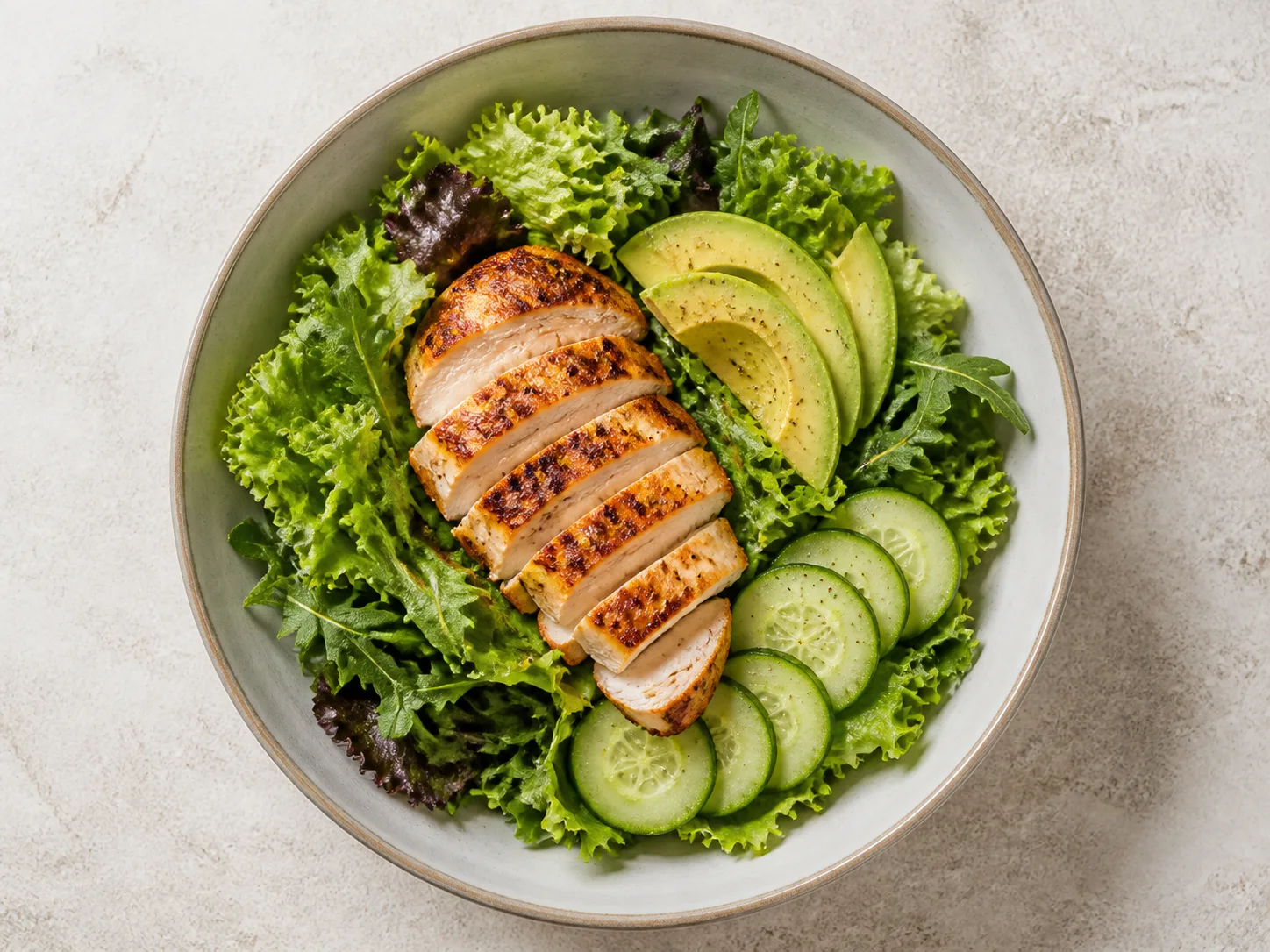 Chicken, avocado, cucumber, and leafy greens